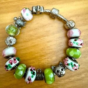 Charming Beaded Bracelet with Green and Pink Accents and Sterling Silver Charms